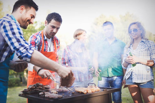 Happy friends enjoying barbecue party - Zdjęcie, obraz