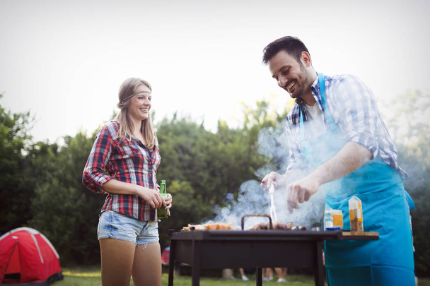 Happy friends enjoying barbecue party - 写真・画像