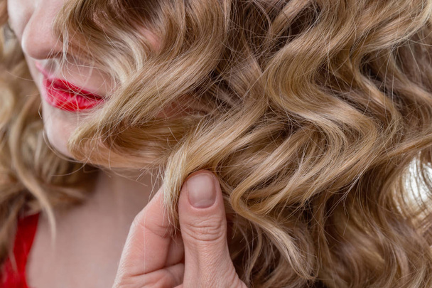 Blond krullend haar en rode lippen - Foto, afbeelding