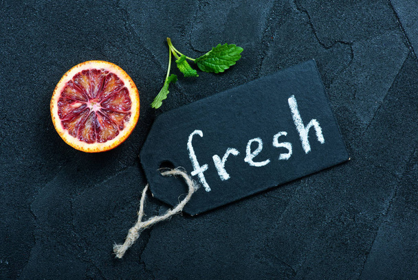 citrus fruit on a table and word fresh  - Фото, зображення