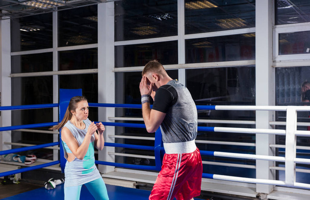 Jonge sportieve man en vrouw in actie voor het beoefenen van boksen  - Foto, afbeelding
