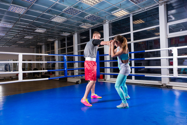 Athletic male and female in sportswear practicing boxing in regu - Foto, Imagen