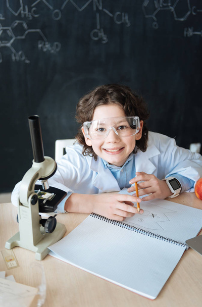 Smiling little scintist working on the microbiology project at school - 写真・画像
