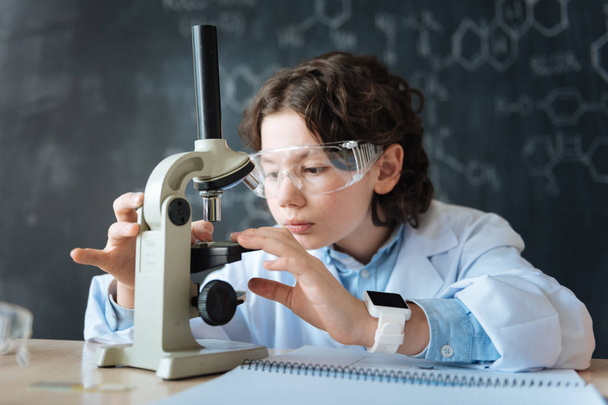 Charming little scientist studying biotechnology at school - Photo, image