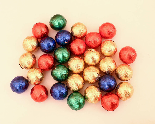 Colorful round chocolate candies in red net sack isolated on whi - Φωτογραφία, εικόνα