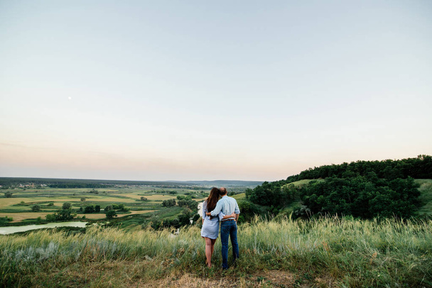 Couple in love is hugging on a hill. Free space - Photo, Image