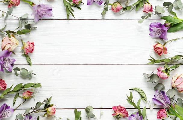 Frame from the pattern of dried flowers on a white wooden background.Top view.Copy space. - Фото, зображення