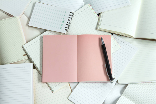 Manny empty notebook paper and note pad background with one pink - Photo, Image
