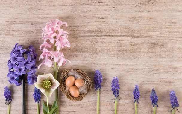 Easter retro background with hyacinth flowers in a row on light brown stone - Photo, Image