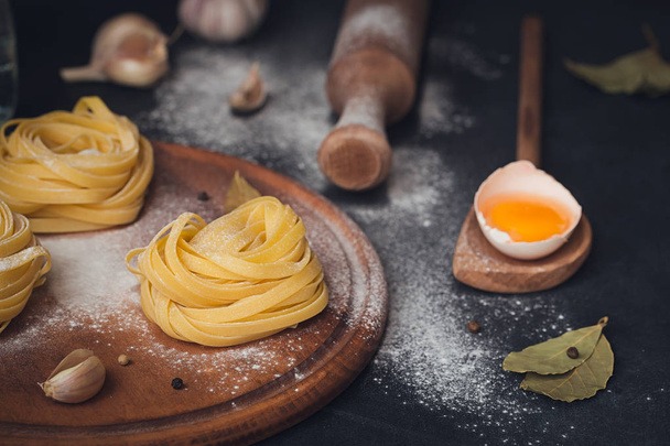 Raw homemade pasta with flour and spices on the rustic backgroun - 写真・画像