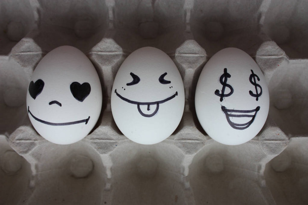 Eggs with faces photo for your design. in the box - 写真・画像