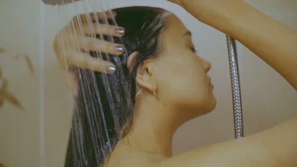 The girl washes in the shower. - Video, Çekim