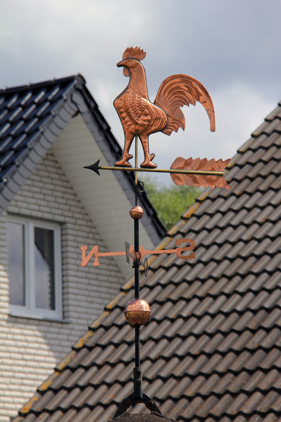Gouden weathercock op het dak - Foto, afbeelding