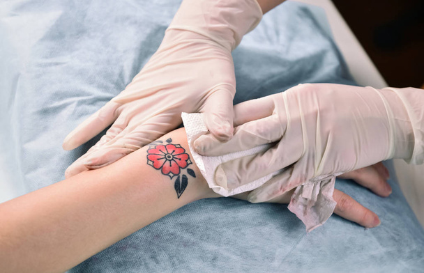 Tatuaje artista haciendo un tatuaje en salón de tatuajes
. - Foto, imagen