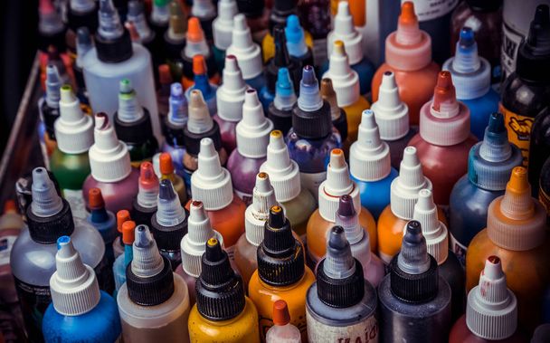 many professional bottles with colored ink for tattoos. - Fotografie, Obrázek