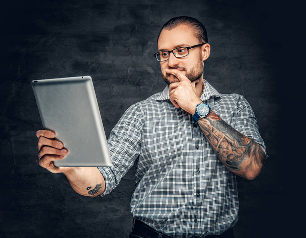 Bearded man holds tablet PC  - Photo, Image