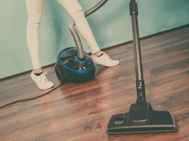 Woman legs and vacuum cleaner - Фото, изображение