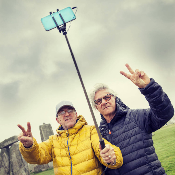 mature men friends take a selfie in the Stonehenge archaeologica - Фото, зображення