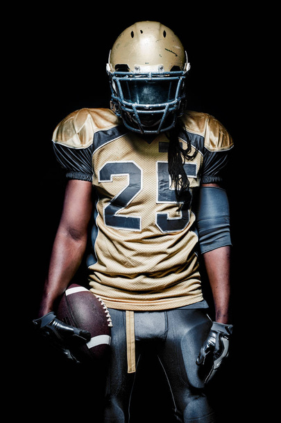 American football sportsman player isolated on black background - Foto, Imagem