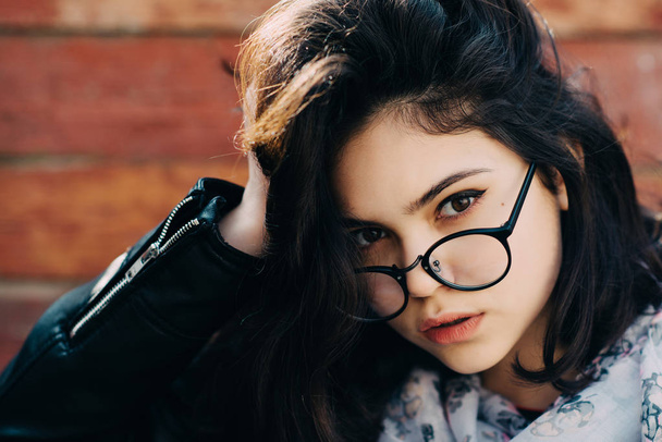 Beautiful happy hipster girl goes in the city. Closeup of trendy girl face. - 写真・画像
