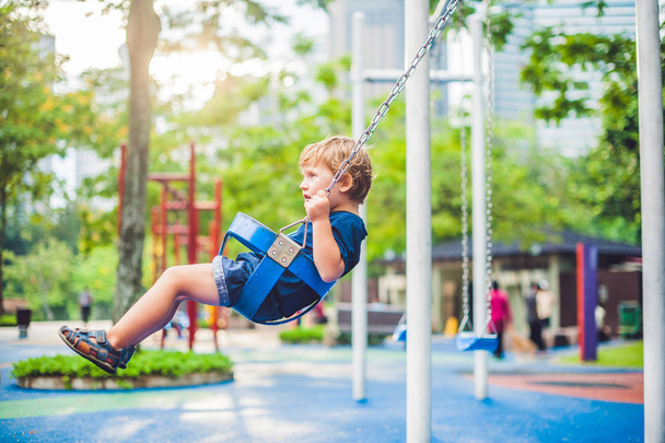 little boy on a swing in the park.  - Fotoğraf, Görsel
