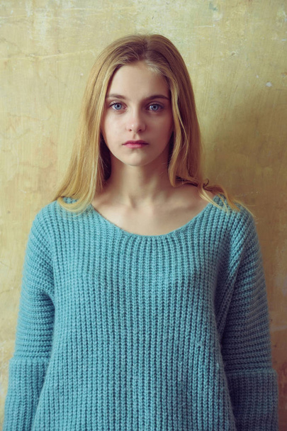 Pretty young girl with blond hair in fashionable sweater - Foto, Bild