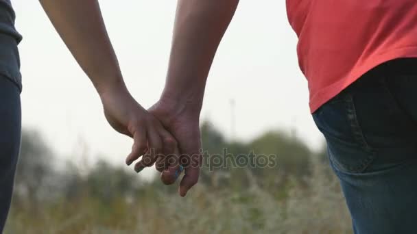 Young couple joining hands outdoor. Man and woman taking arms on nature background. Male and female hands comforting and stroking each other. Symbol of love and devotion. Romantic outside. Close up - Footage, Video