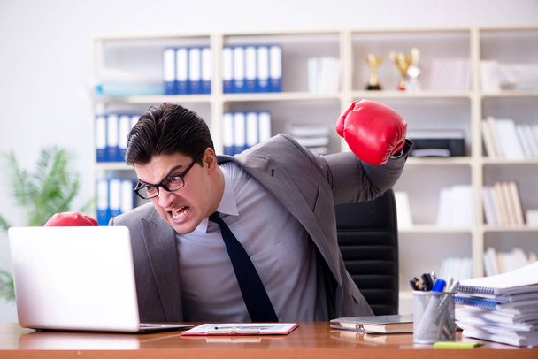 Angry aggressive businessman with boxing gloves - Photo, Image
