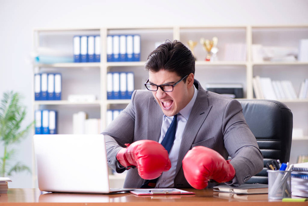 Angry aggressive businessman with boxing gloves - Fotó, kép