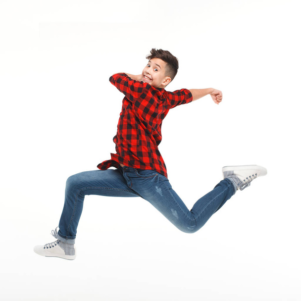 boy jumping and looking at camera - Fotó, kép