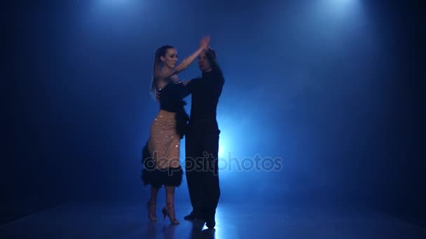 Happy couple dancing rumba in smoky studio with blue spotlight - Filmagem, Vídeo