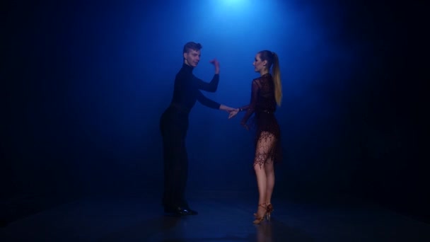 Jive dancing couple of professional elegant dancers in smoky studio - Кадри, відео