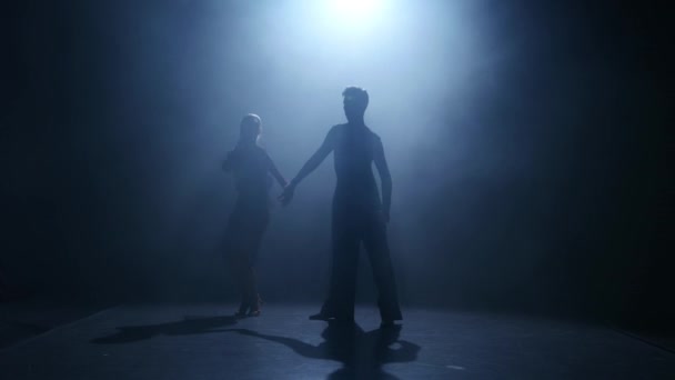 Dance element from the jive, silhouette couple ballroom. Smoke background - Footage, Video