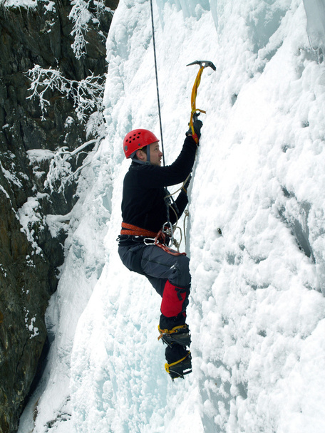 Man climbing frozen waterfall - Zdjęcie, obraz