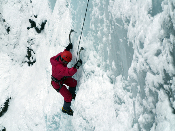 Man climbing frozen waterfall - Valokuva, kuva