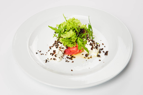 Vegetable salad with white sauce and grilled crumbs on plate. - Fotó, kép