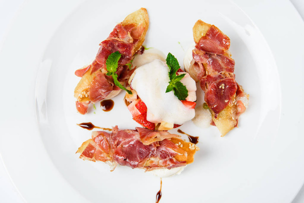 Baguette pieces covered with grilled bacon on plate served luxury. - 写真・画像