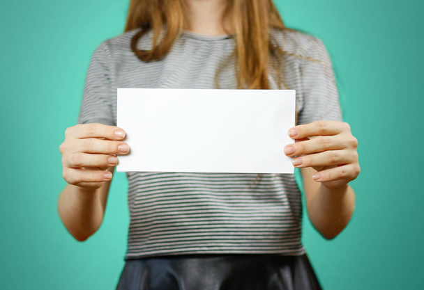 Woman showing blank white flyer paper. Leaflet presentation. Pam - Foto, Imagen