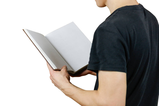Closeup of guy in black t-shirt holding blank open white book on - Photo, image