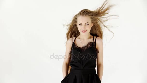 Girl model posing, smiling, advertising clothes on white background - Video, Çekim