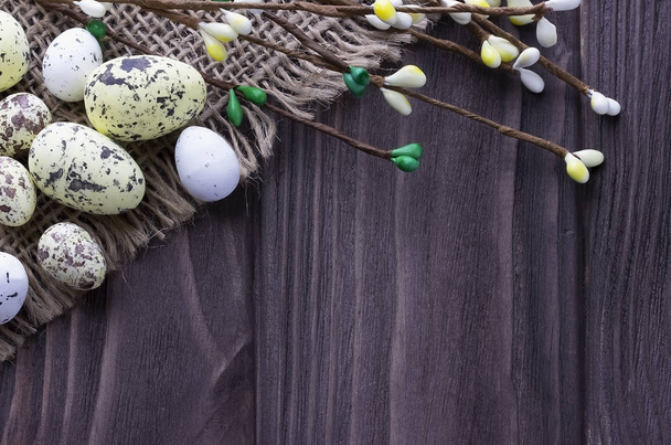 Easter eggs in the nest on burlap cloth with pussy willow branches. - Photo, Image