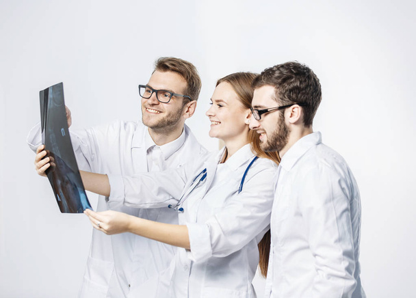 group of diagnosticians with x-rays on a white background - Фото, изображение