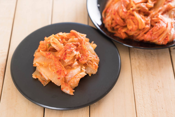 kimchi on wood background - korean food - 写真・画像