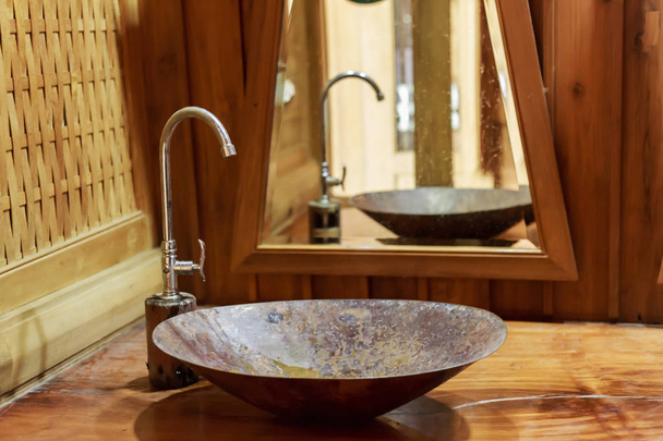 Vintage brass wash basin and faucet in wooden bathroom. - Photo, image