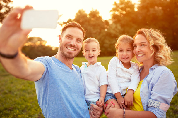 Male and female with son taking photo - Foto, Imagem