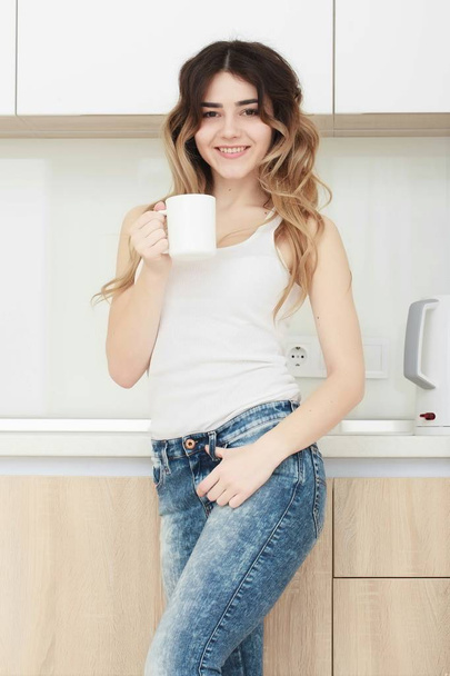 young woman drinking coffee in the kitchen. - Fotó, kép