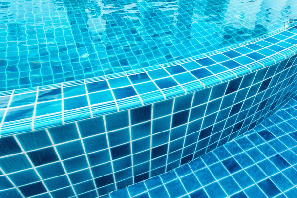 Ceramic tile of swimming pool with water reflection. - Photo, Image