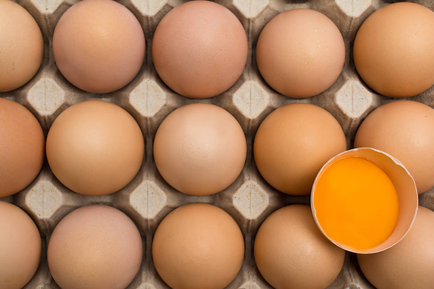 Background of chicken eggs in a cardboard tray. - Φωτογραφία, εικόνα