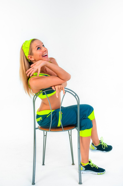 Young fitness instructor sitting on chair - 写真・画像