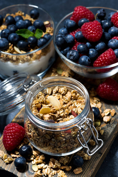 crispy muesli and fresh berries for breakfast, vertical top view - Foto, Imagen